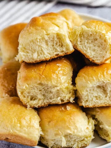 dinner rolls stacked on a plate