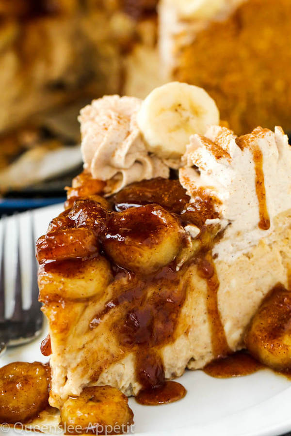 slice of banana cheesecake topped with bananas foster