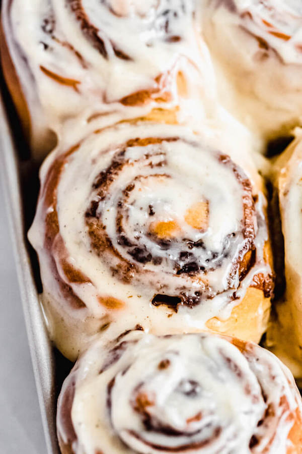 close up of frosted cinnamon rolls