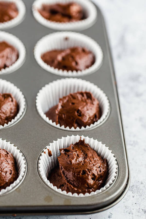 chocolate cupcake batter in cupcake liners