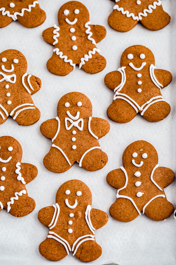 decorated gingerbread man holiday cookies on parchment paper