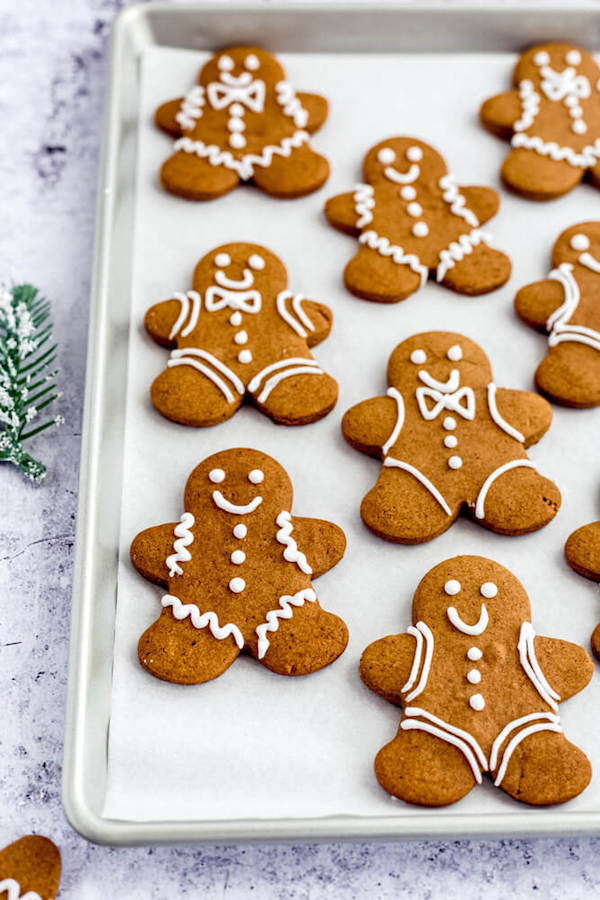 decorated gingerbread cookies on a parchment lined baking sheet