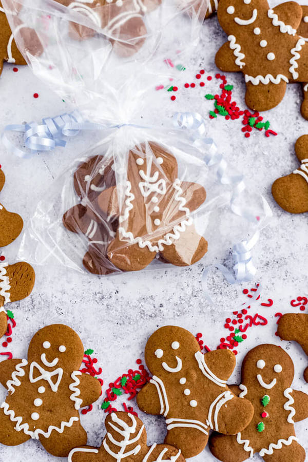 gingerbread man cookies wrapped in a treat bag with blue ribbon