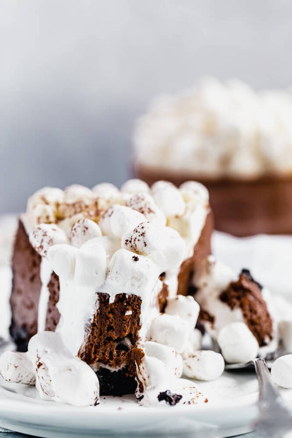 slice of marshmallow topped chocolate cheesecake with bite taken out