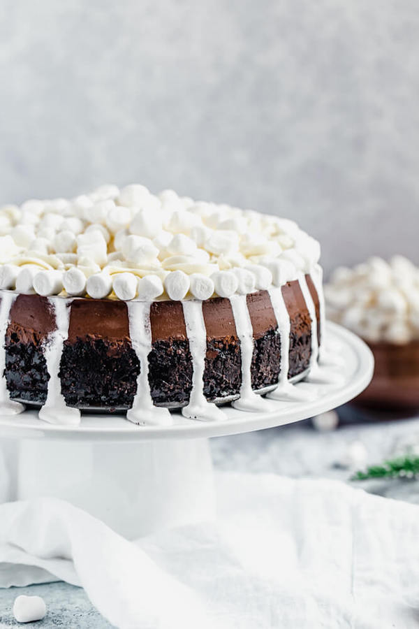 side of chocolate marshmallow cheesecake with marshmallow drip and topping