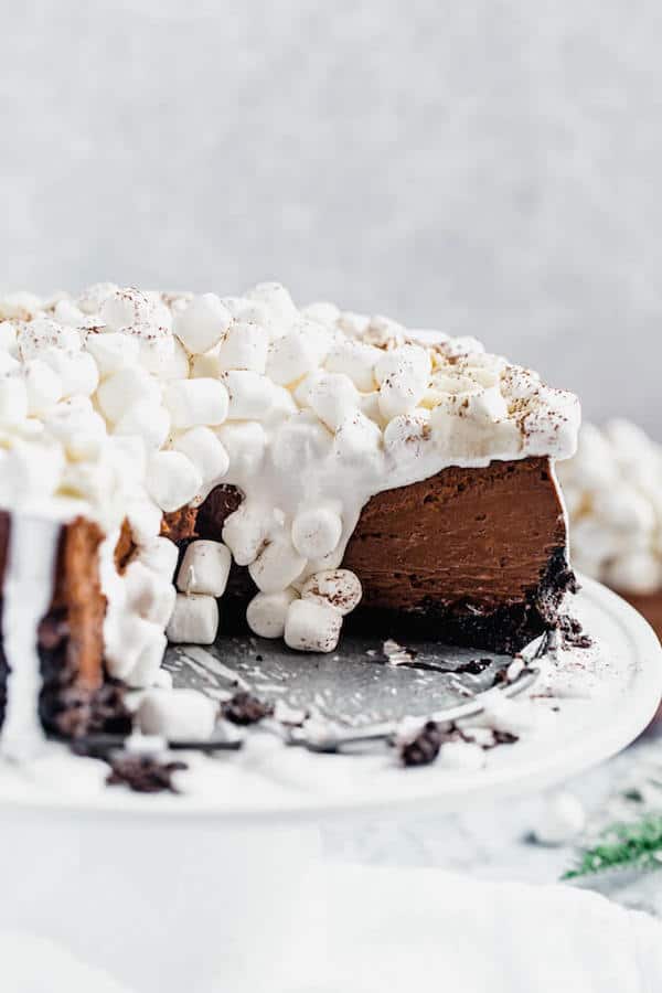 inside of sliced chocolate cheesecake with marshmallows dripping down