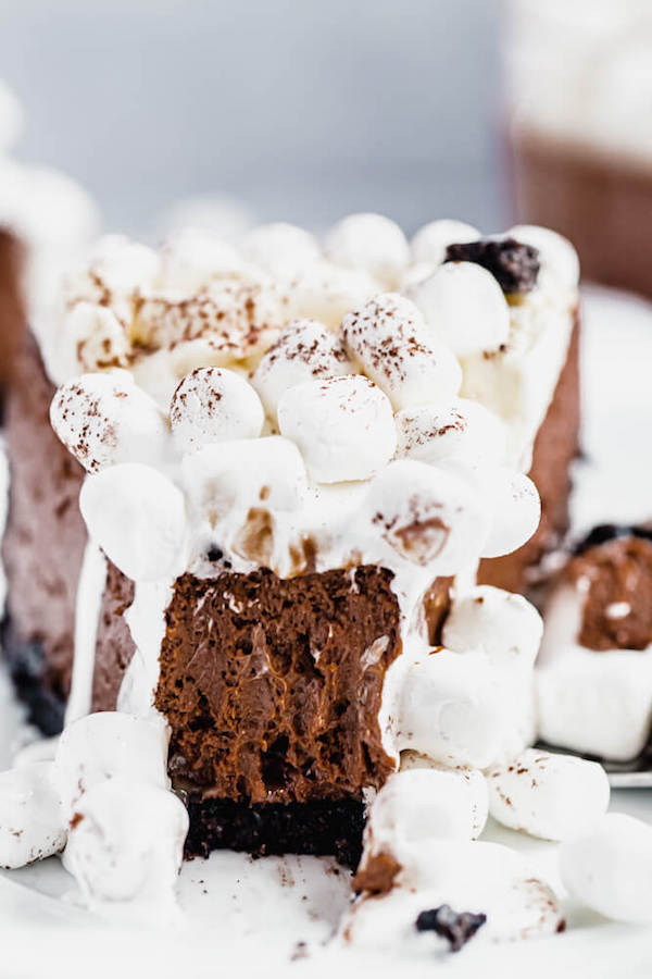 close up of marshmallow topped cheesecake with bite taken out