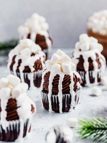 hot chocolate cupcakes with hot chocolate in the background