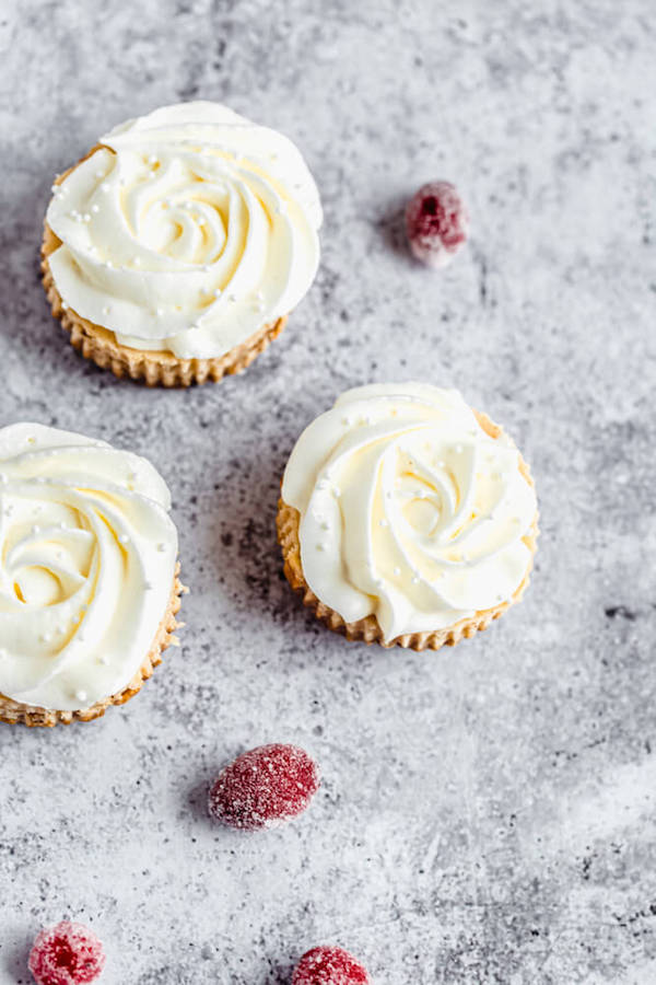 mini eggnog cheesecake topped with an eggnog whipped cream rosette