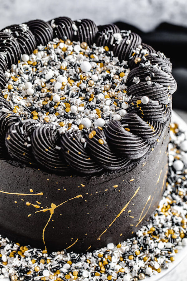 close up of gold and black sprinkle cake