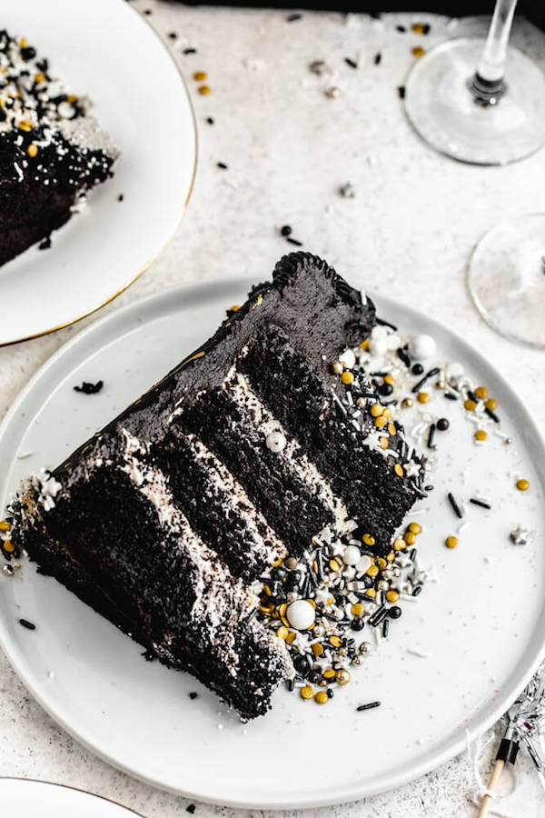 black dark chocolate champagne cake on a white plate