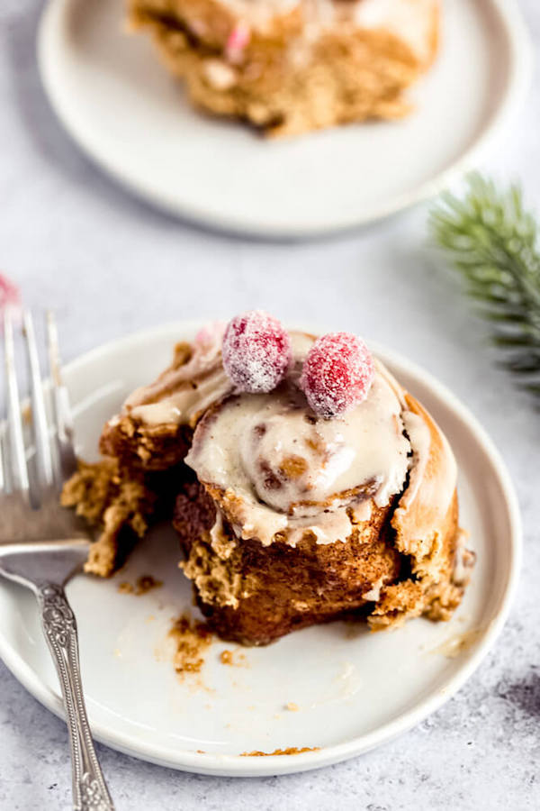 half eaten gingerbread cinnamon roll on an appetizer plate