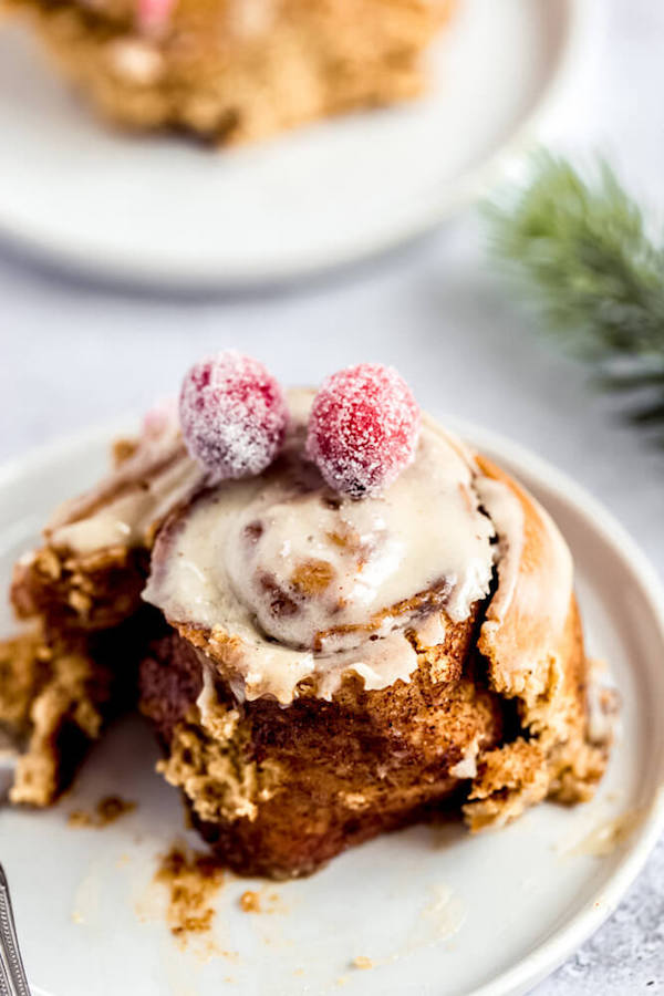 half eaten gingerbread cinnamon roll on an appetizer plate