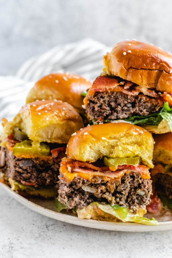 hamburgers stacked on a white plate