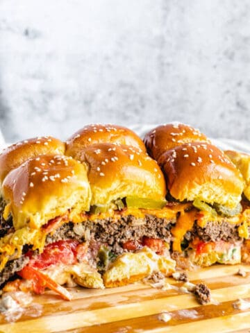 mini burgers on a wood cutting board