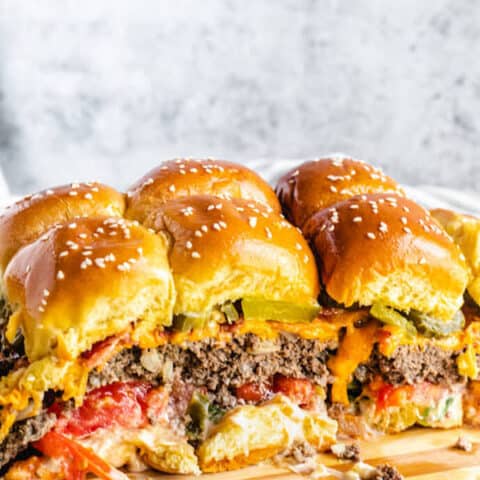 mini burgers on a wood cutting board