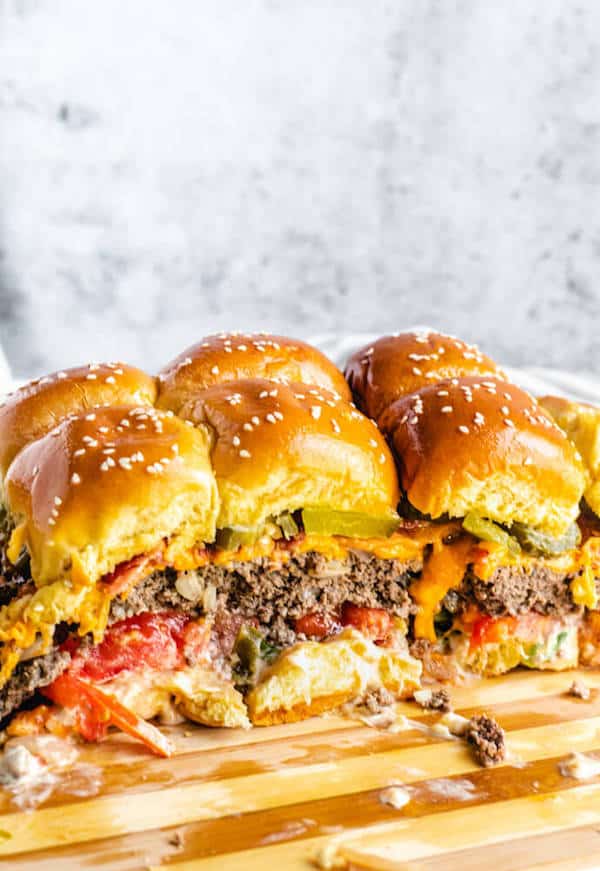 mini burgers on a wood cutting board