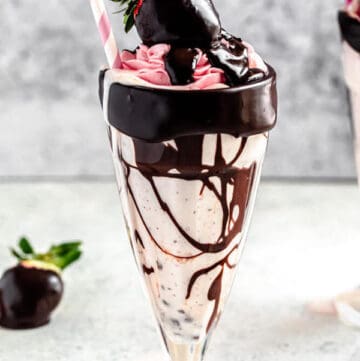 chocolate chip and strawberry milkshake in a milkshake glass