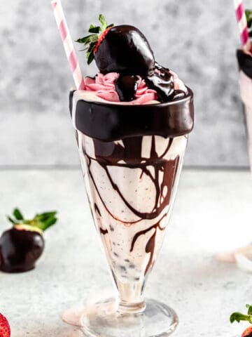 chocolate chip and strawberry milkshake in a milkshake glass