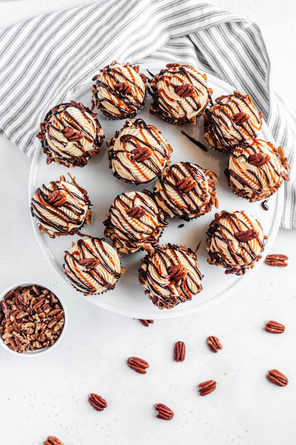 top view of chocolate caramel pecan cupcakes on a cake stand