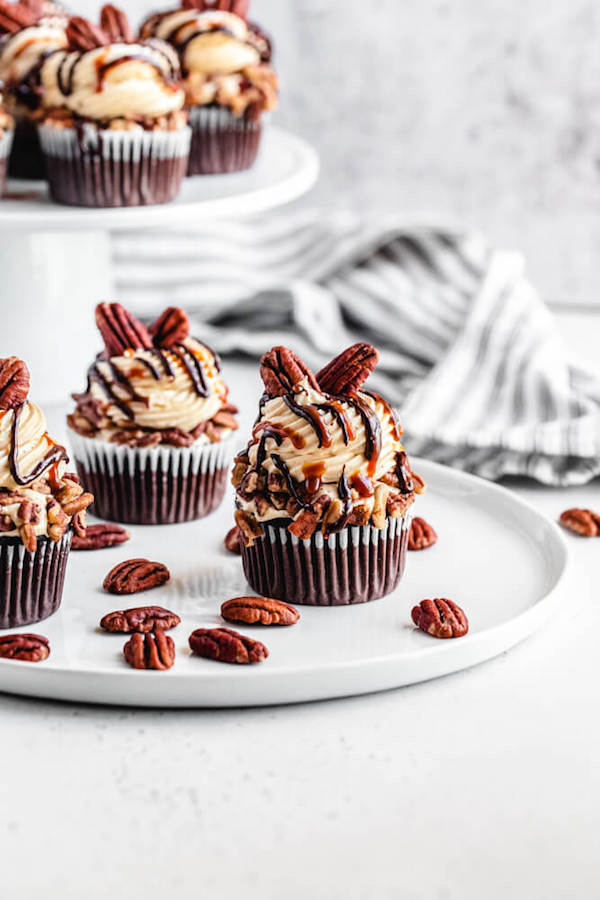 pecan and caramel chocolate flavoured cupcakes on a white plate