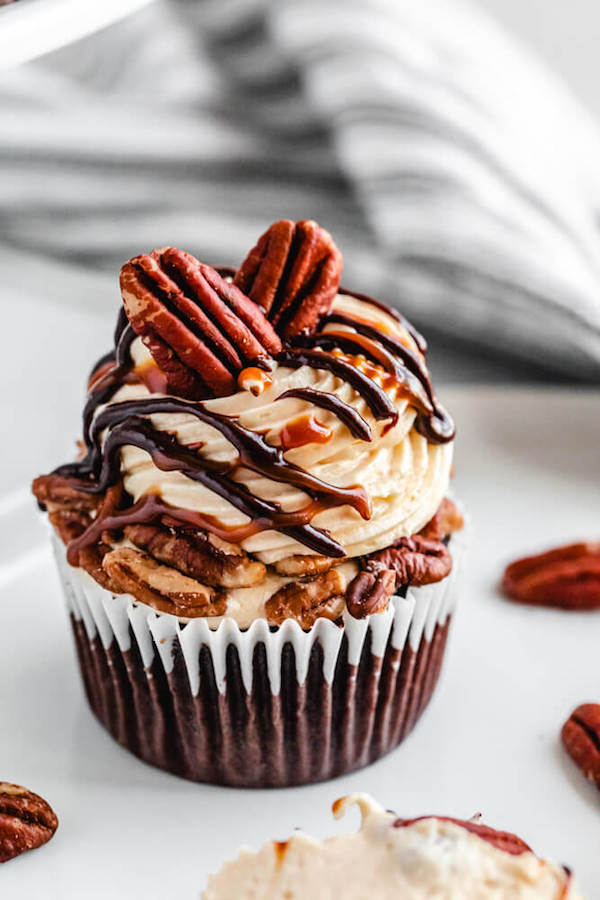 chocolate cupcake topped with caramel frosting and pecans