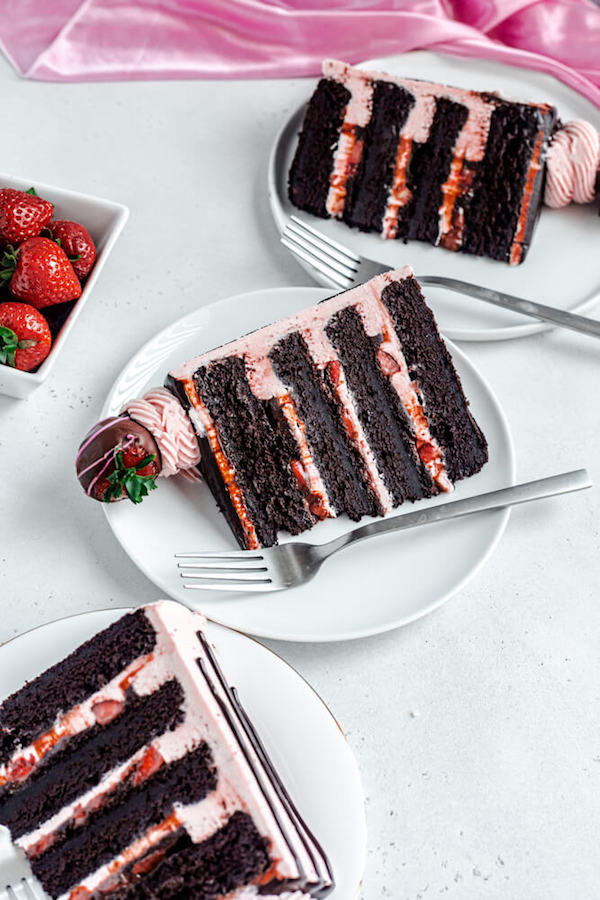 three slices of cake on white plates