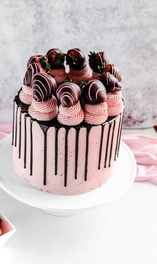 chocolate and strawberry flavoured cake on a cake stand