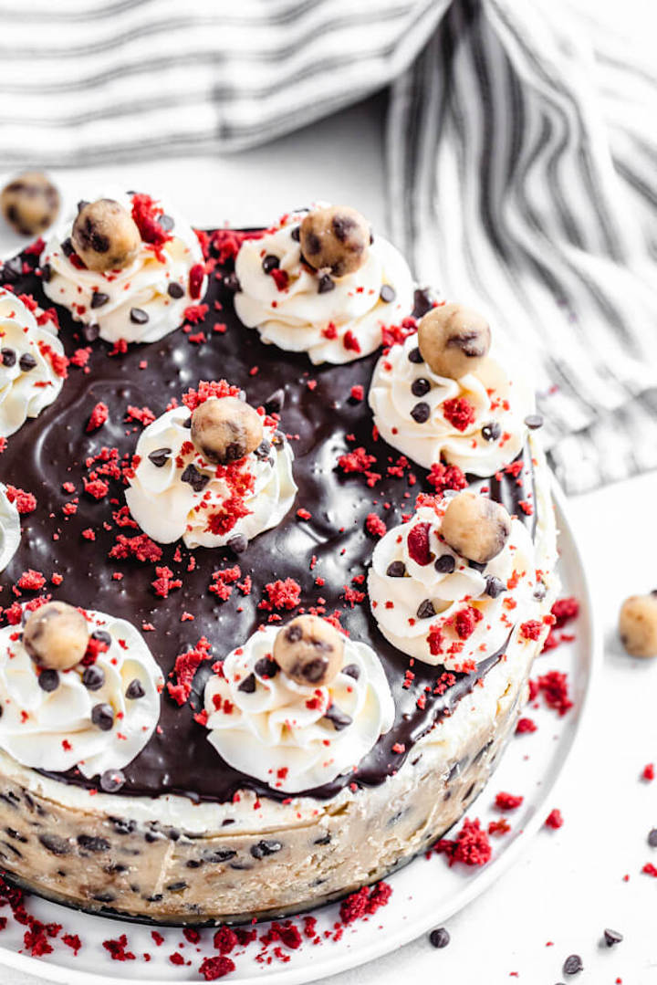 cookie dough and red velvet flavoured cheesecake on a white plate