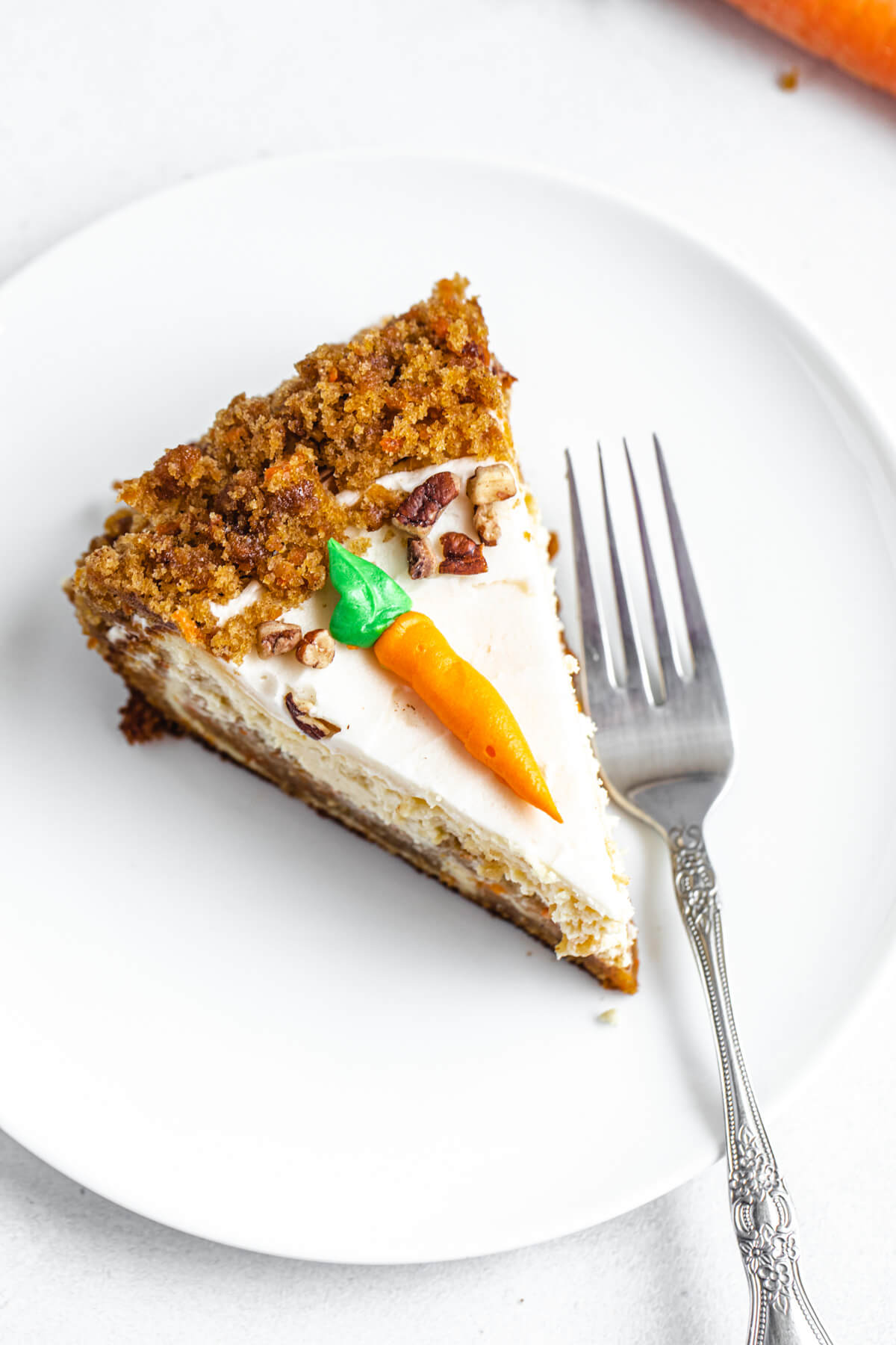 top view of cheesecake slice on a white plate with fork