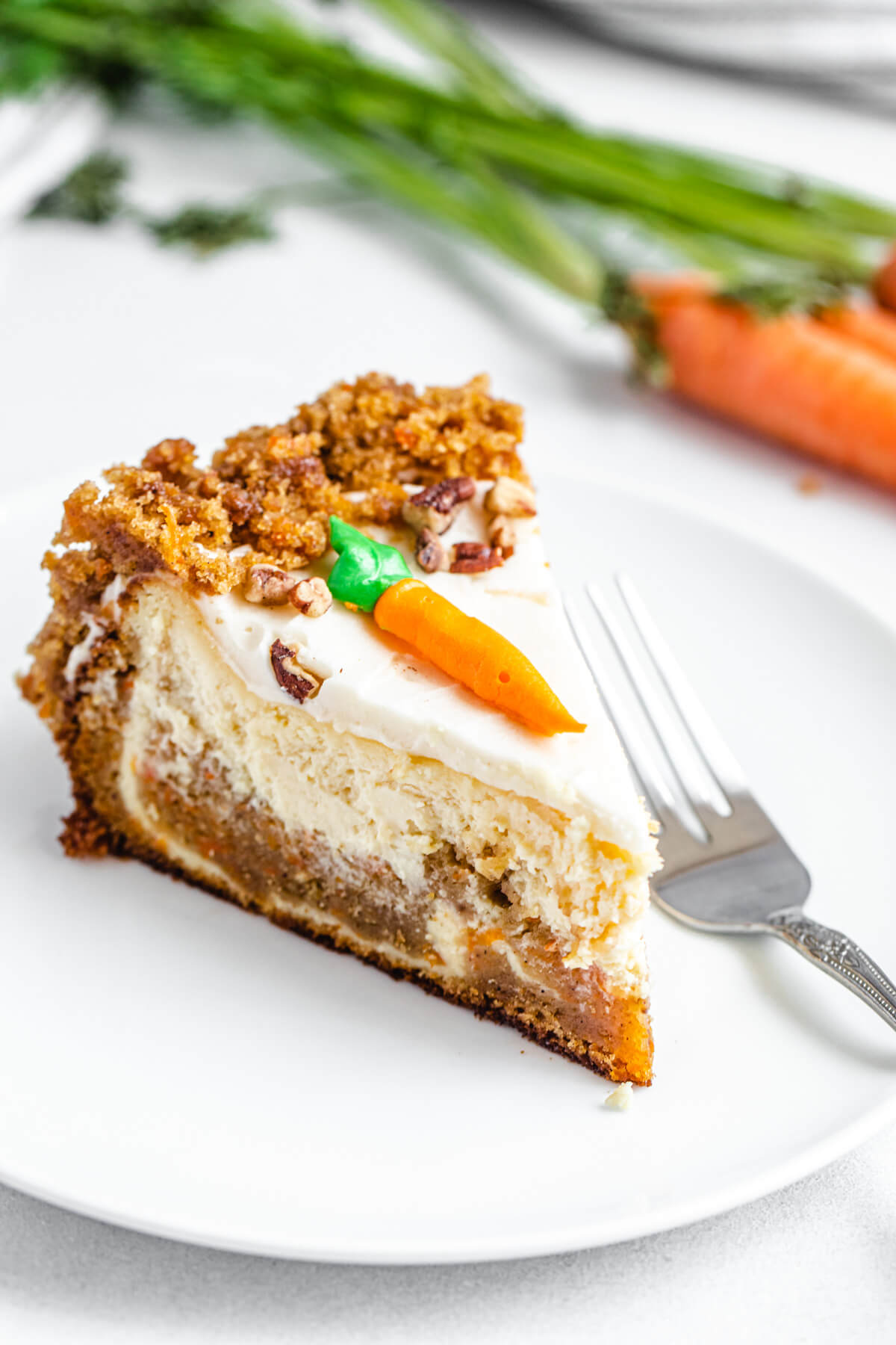 cheesecake slice on a white plate with a fork