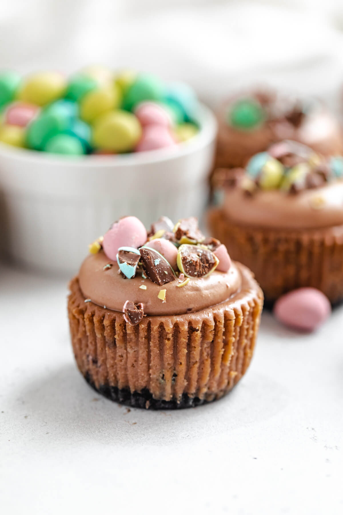 close up of cheesecake cupcake with chocolate Easter eggs in a ramekin