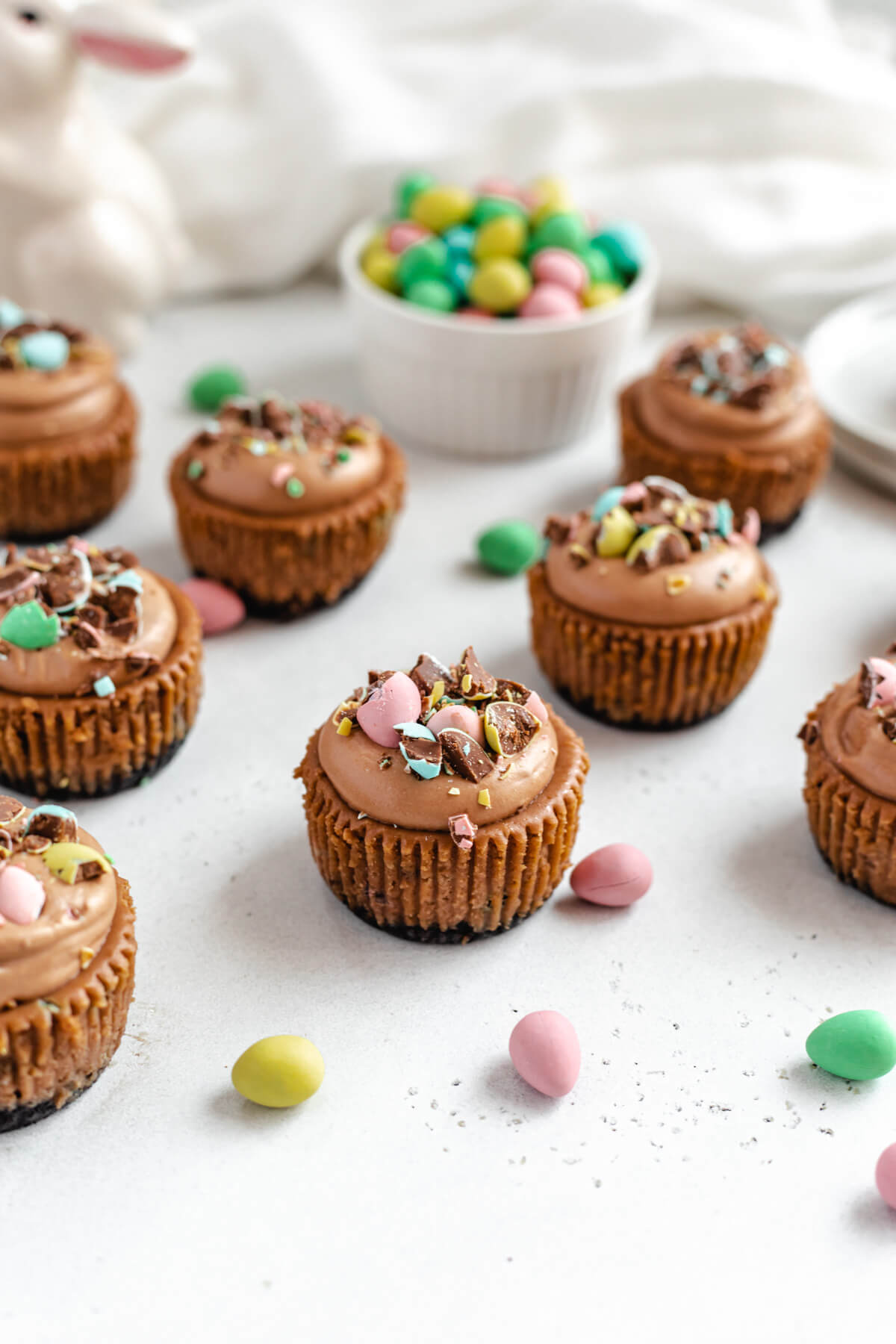 mini cheesecakes topped with mousse and chopped chocolate eggs
