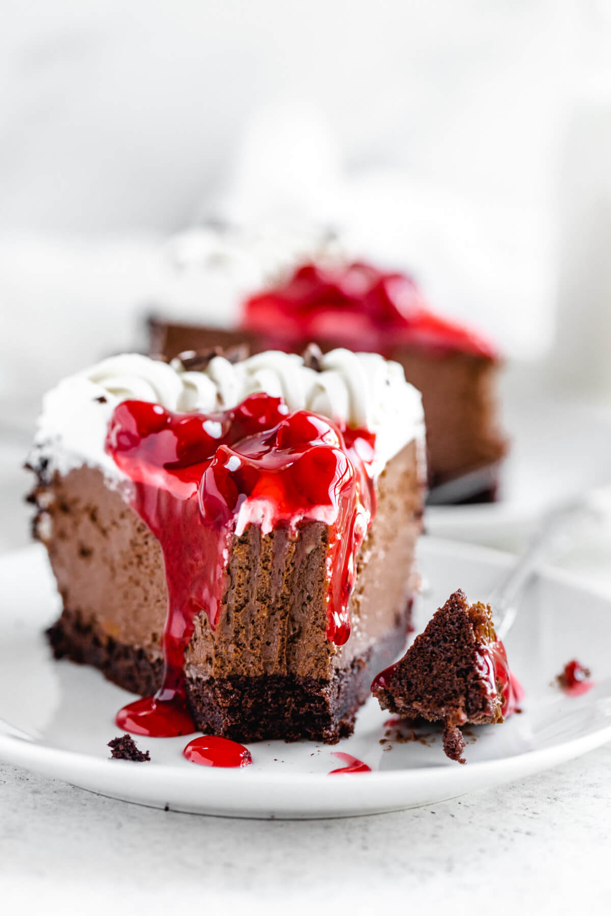 slice of cheesecake with bite taken out on a white plate