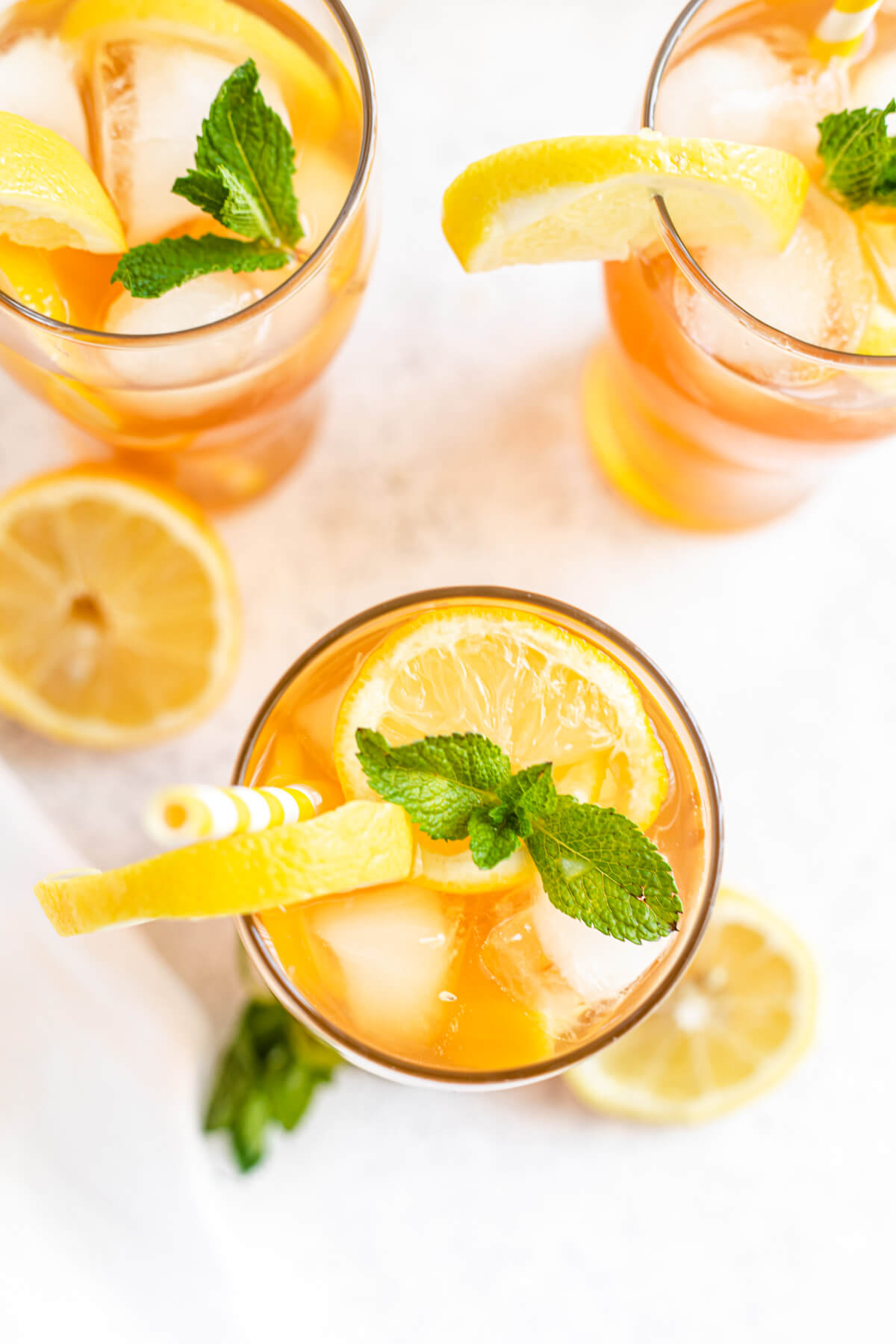 top down shot of sweet tea in a glass topped with ice cubes, fresh mint and sliced lemons