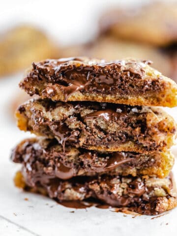 halved chocolate chunk cookies stacked on top of each other