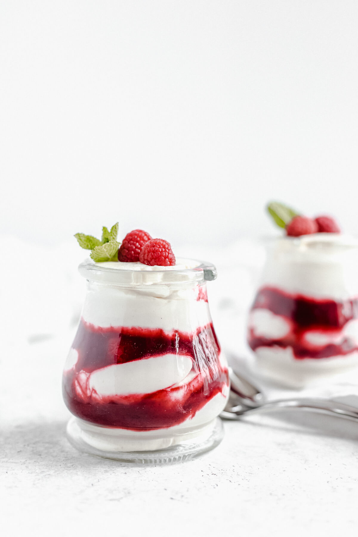 one jar of mousse in the forefront and one in the background