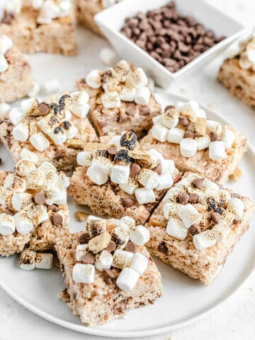 toasted marshmallow topped Rice Krispie treats on a white platter