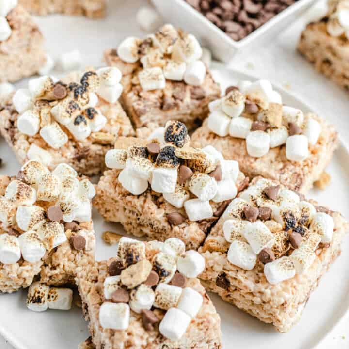 toasted marshmallow topped Rice Krispie treats on a white platter