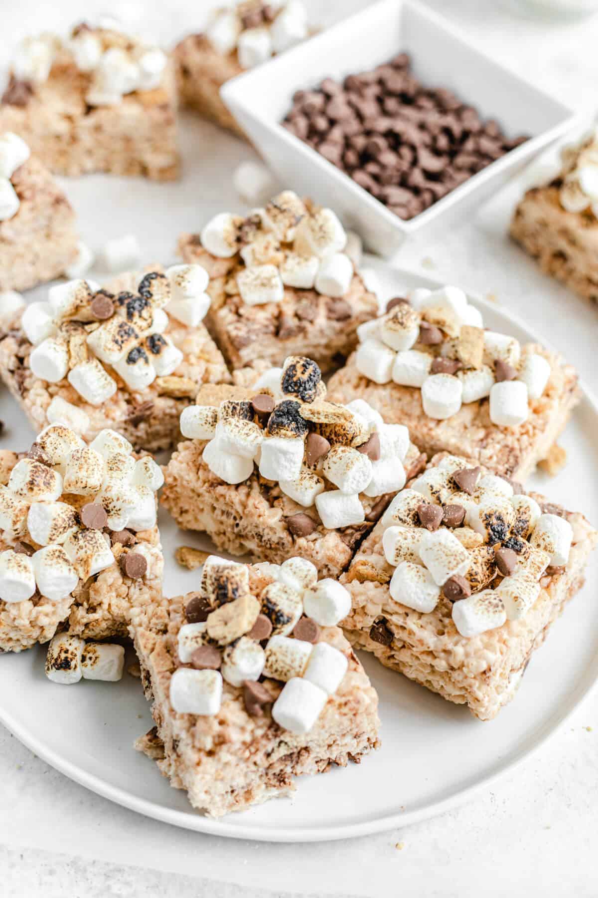 toasted marshmallow topped Rice Krispie treats on a white platter