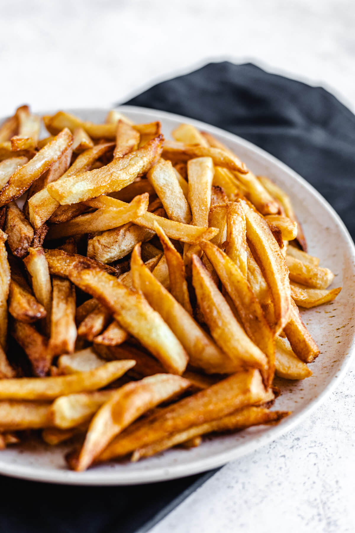 close up of cooked French fries on a plate