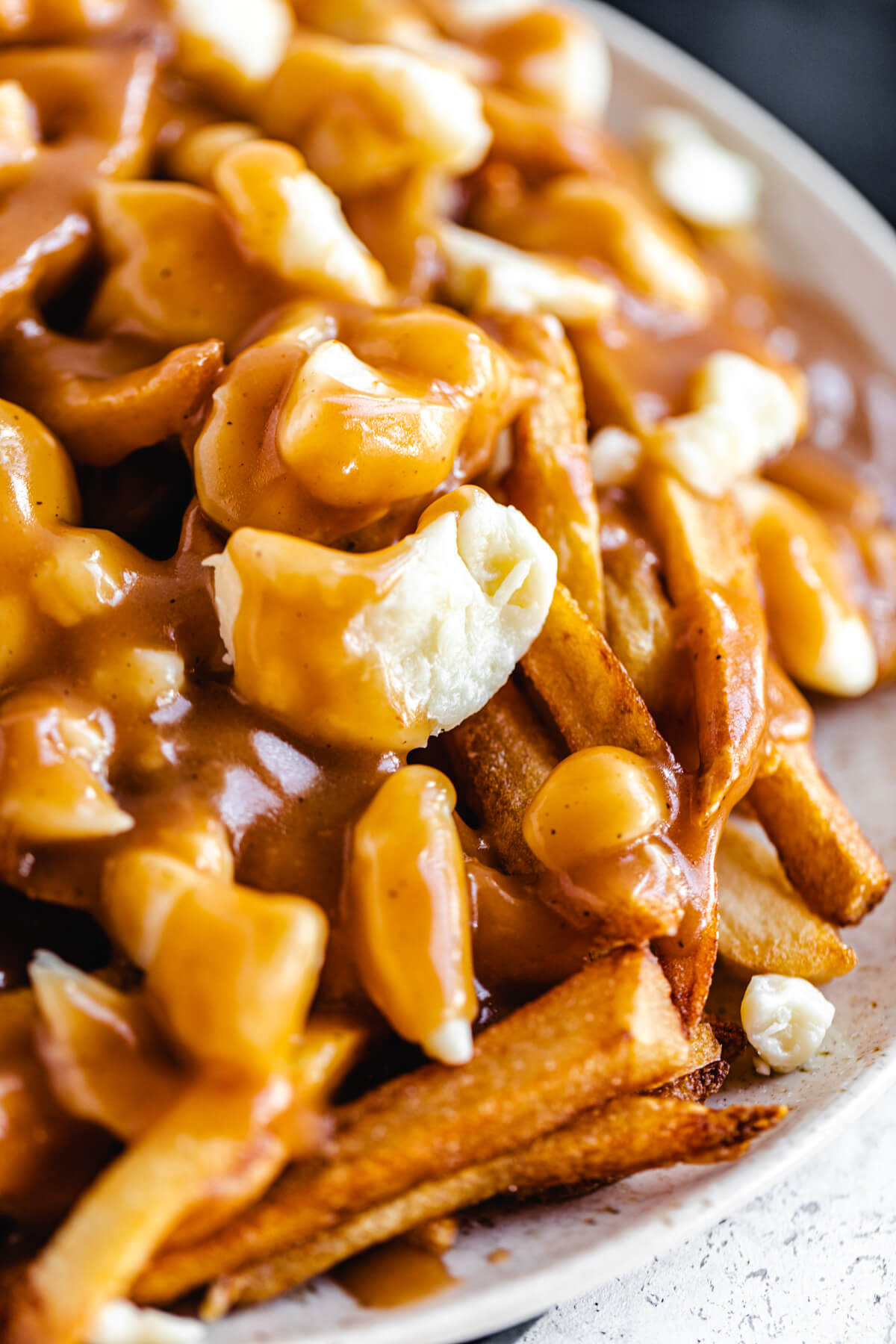 close up of fries and cheese curds covered in gravy