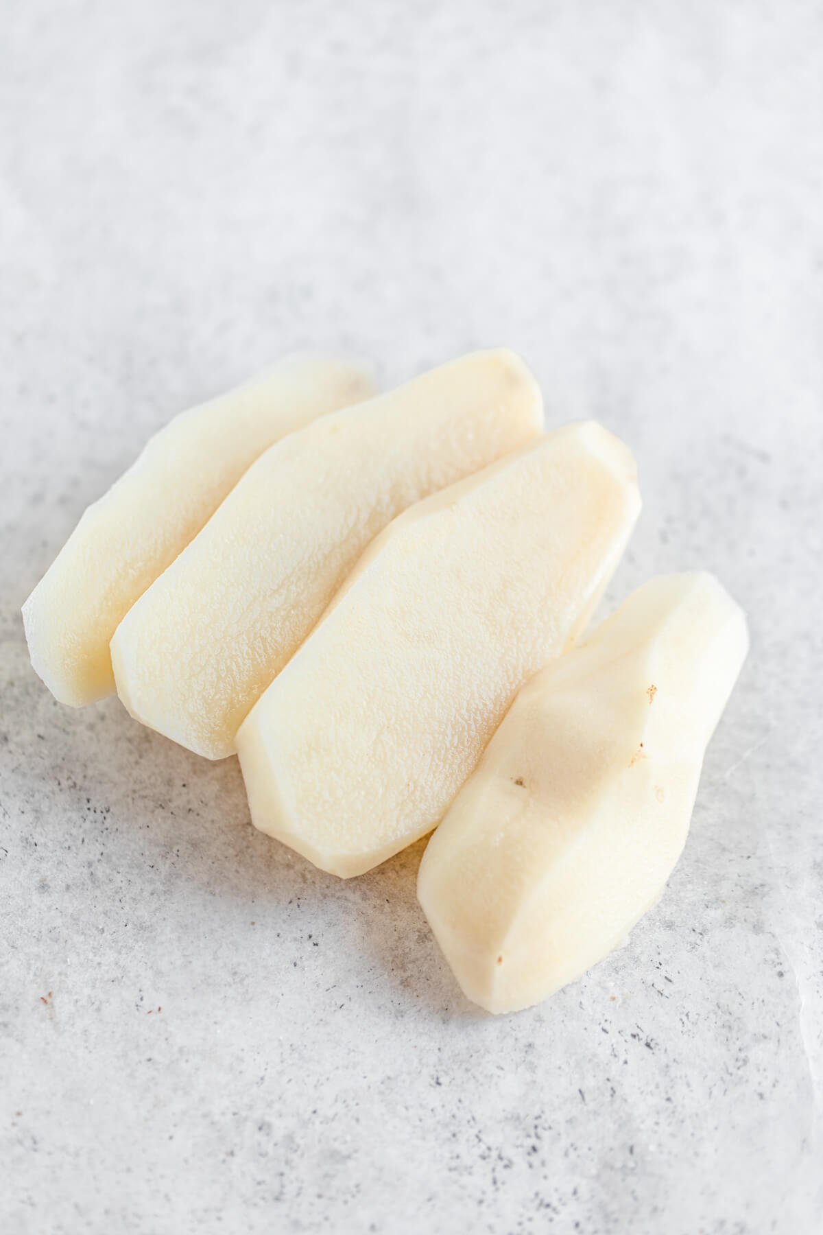 skinned potato sliced into four portions