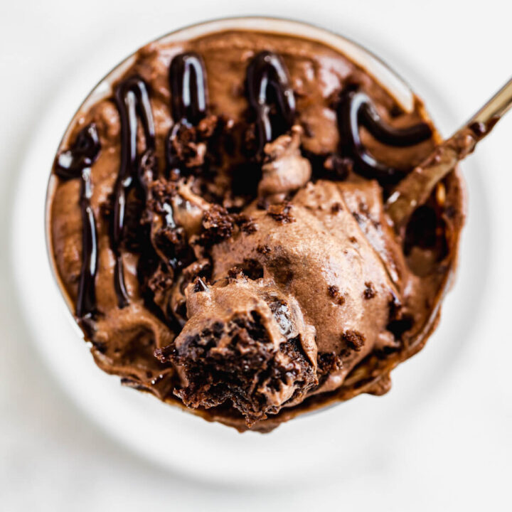 spoonful of mousse and brownie chunks laying on top of glass