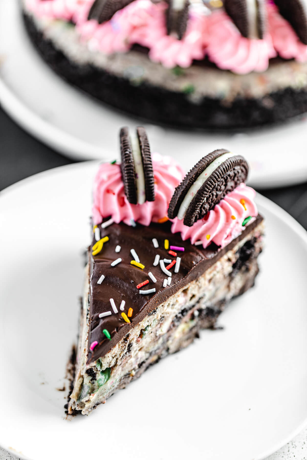 close up of top angled view of cheesecake slice on a white plate