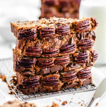 stack of four slices of banana bread, with pecans on the front