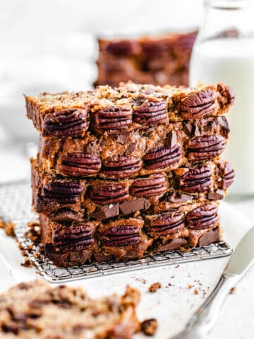 stack of four slices of banana bread, with pecans on the front