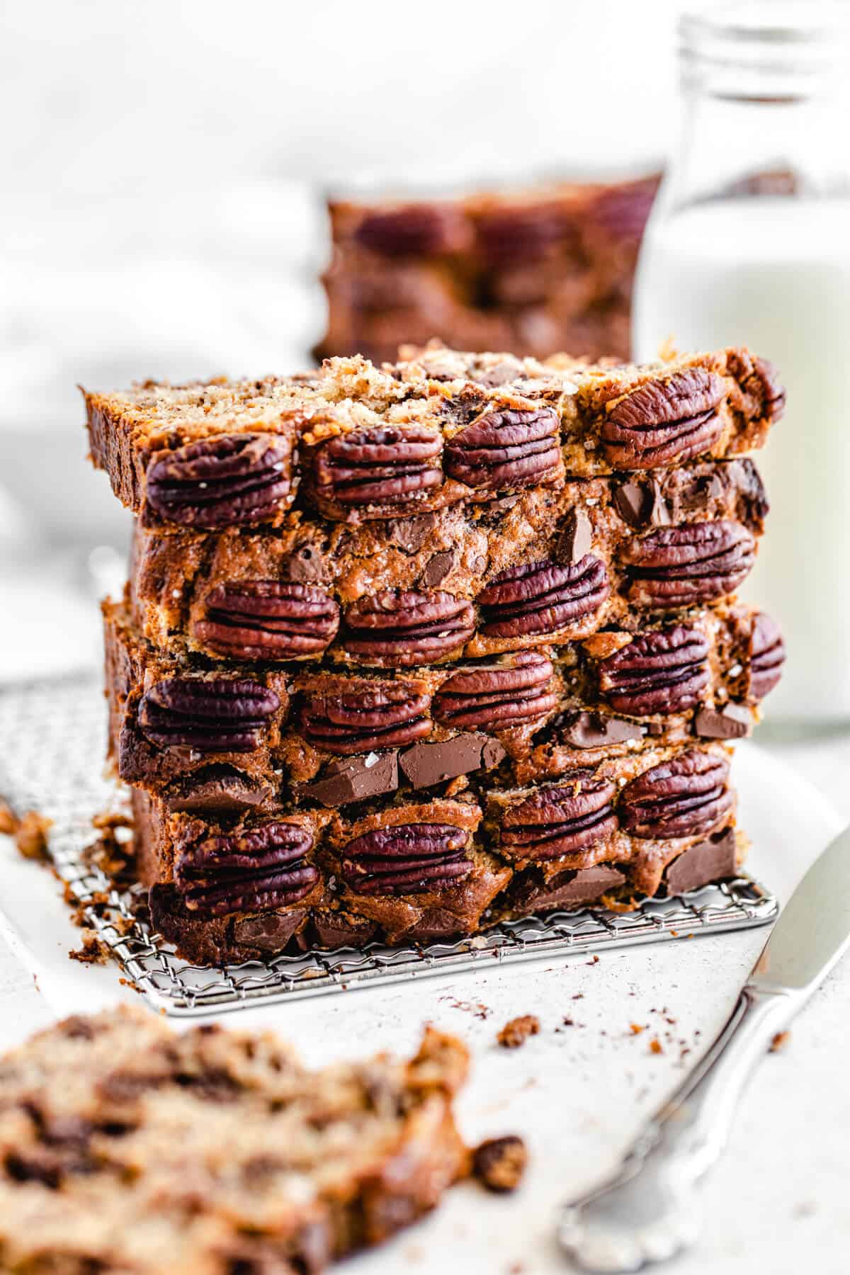 stack of four slices of banana bread, with pecans on the front