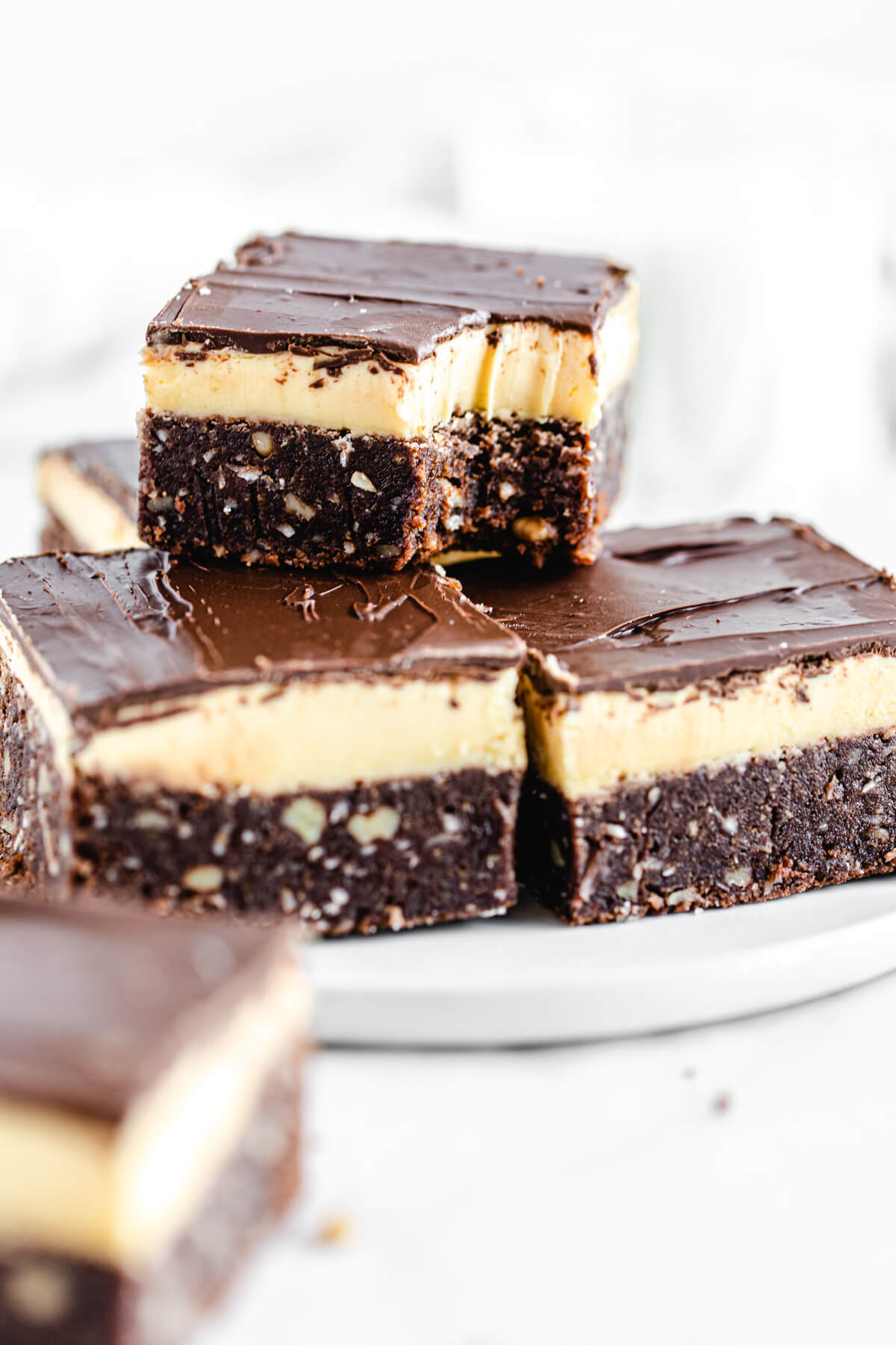 brownies on a white plate with a half eaten brownie on top of them