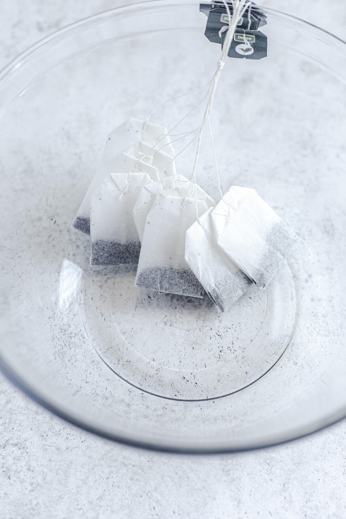 10 black tea bags tied together in a large glass bowl